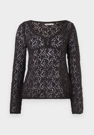 Top nero a maniche lunghe in tessuto di pizzo con trama aperta, caratterizzato da una scollatura a V e tre bottoni sul collo, motivo a diamante testurizzato.