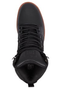 Black lace-up shoe with a textured upper, rubber sole, and padded collar. Features metal hardware and logo detail on the tongue.