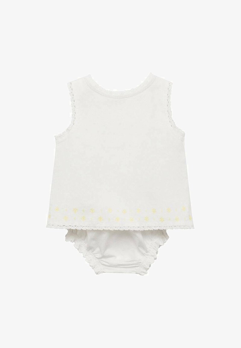 Vitt ärmlöst linne med spetsdetalj och gul blommönster vid fållen, matchat med en vit blöjbyxa. Mjuk bomullstyg.