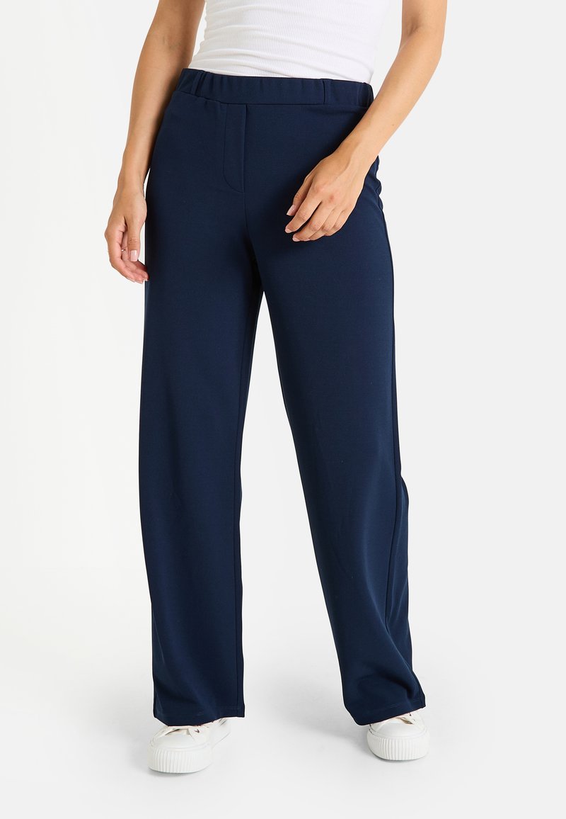 Pantalones de pierna ancha en azul marino, fabricados con un tejido suave, que cuentan con una cintura elástica y bolsillos laterales para mayor funcionalidad y comodidad.