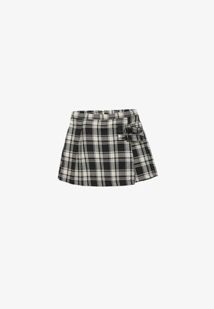 Jupe mini à carreaux noir et blanc avec un design plissé, dotée d'une bande à la taille et d'un accent en nœud sur le côté pour plus de détail.