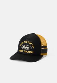 Black and yellow trucker cap with "Ford Motor Co. Truck Country" text and Ford logo on the front panel, mesh back, and adjustable strap.