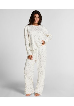 Lichtgewicht, crèmewitte pyjama set met een geribde structuur, voorzien van een bloemenpatroon, lange mouwen en losse broek.