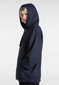 Sweat-shirt à capuche surdimensionné bleu marine en mélange de coton. Doté d'une poche avant, de poignets élastiques et d'une capuche avec cordon de serrage. Détail de logo minimaliste sur la poitrine.