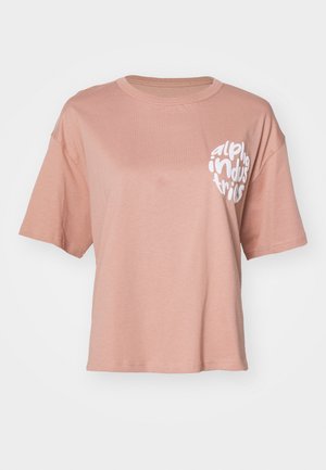 Lys rosa kortermet t-skjorte med hvit "alpha industries" tekst trykket på øverste venstre bryst.