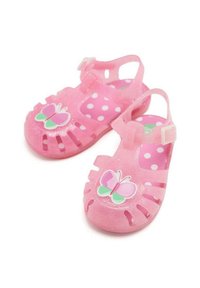 Sandalias de plástico transparentes rosas con diseño de mariposa y patrón de lunares; con la puntera abierta, correa ajustable y laterales troquelados.