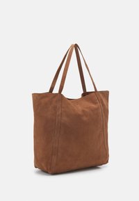 Brown suede tote bag with two long handles, a spacious rectangular body, and minimal stitching details on the sides. Textured surface.