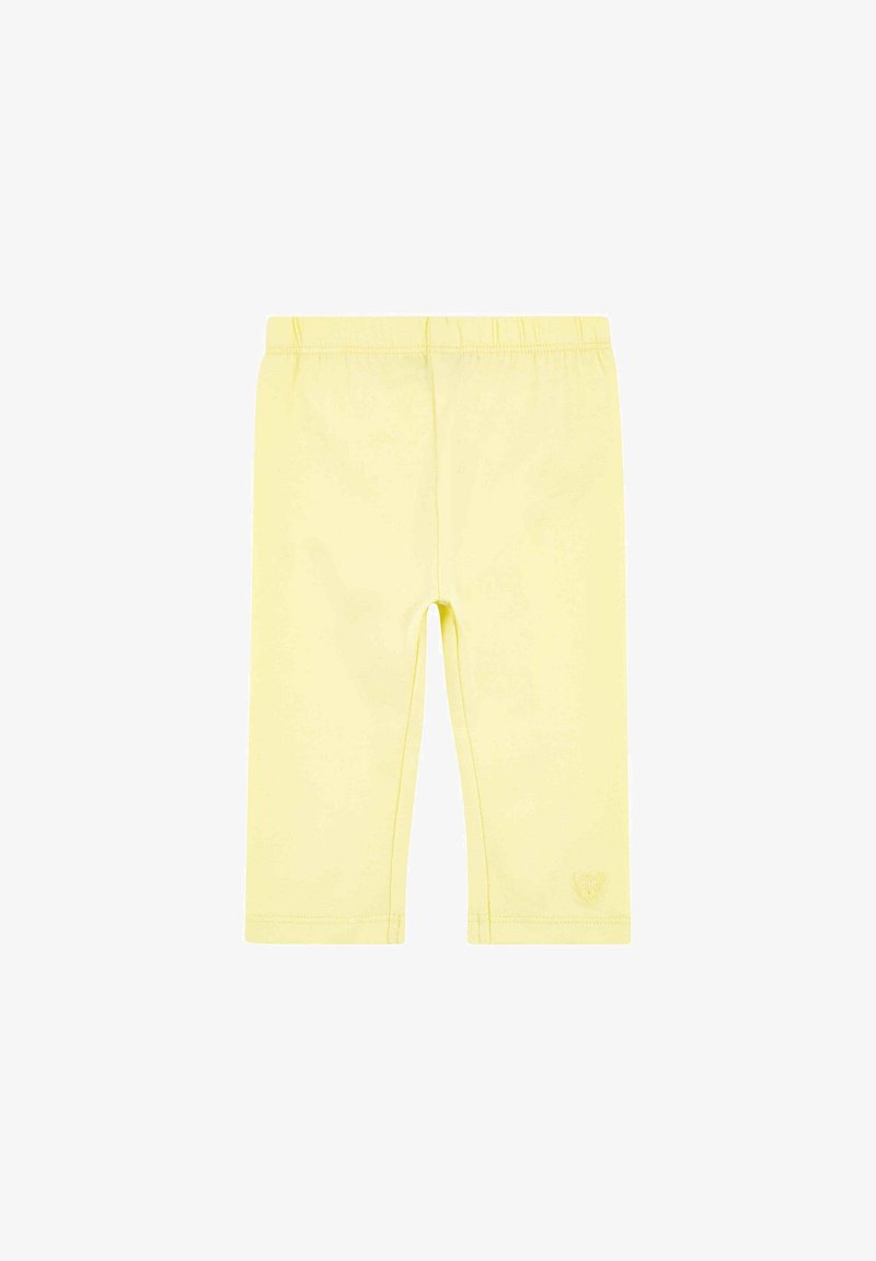 Leggings jaunes extensibles en matériau doux, dotés d'une taille élastique et d'un petit logo sur l'ourlet inférieur. Coupe ajustée, longueur cheville.