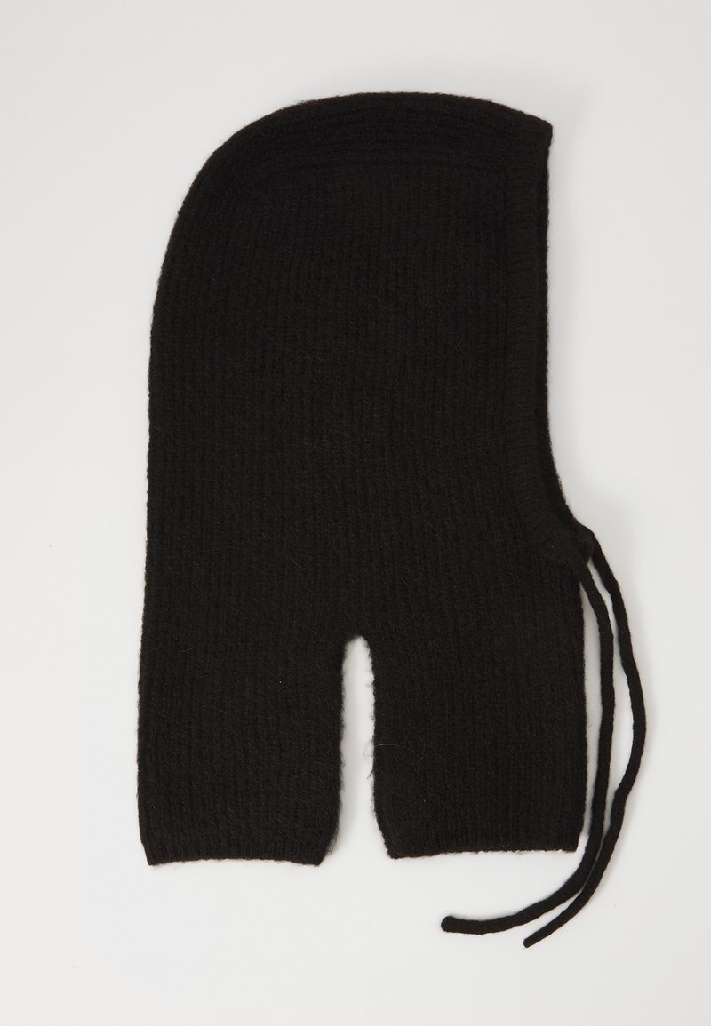 Black knitted balaclava with openings for eyes and mouth, featuring side ties for adjustment, laid flat on white background.