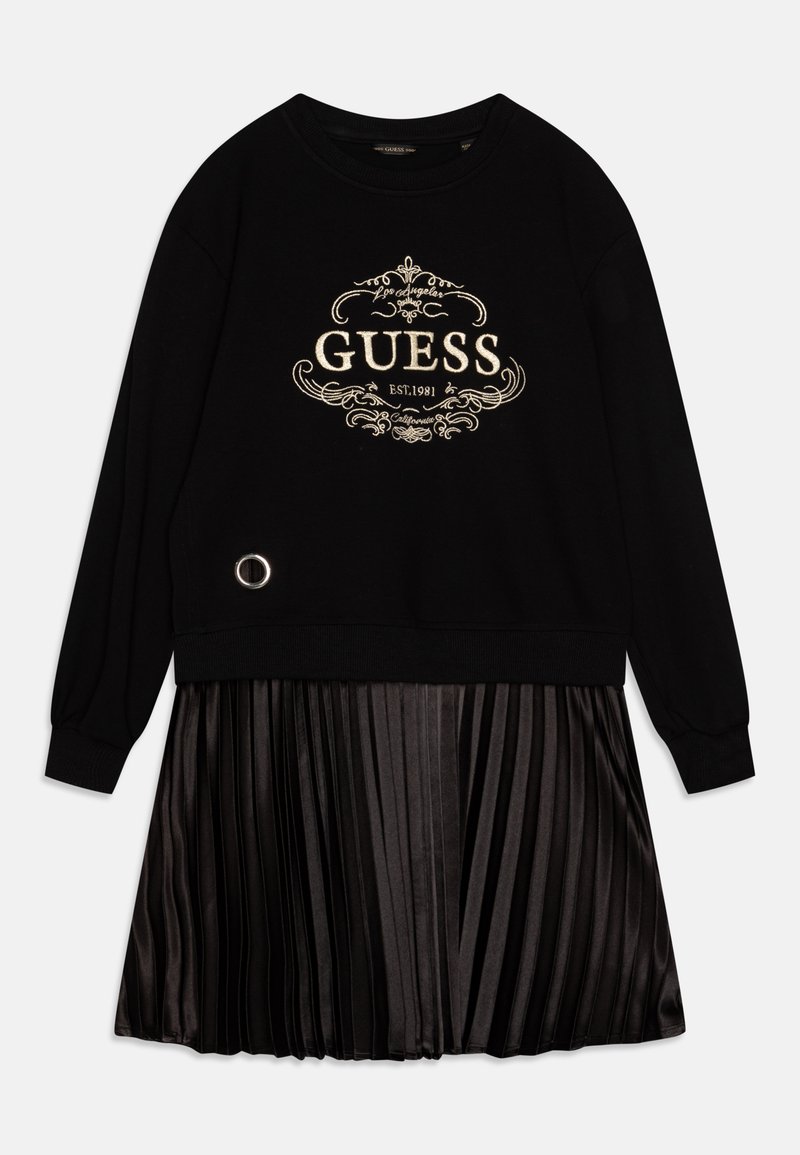 Schwarzes Sweatshirtkleid mit goldener "GUESS"-Logo, plissierten Satinrock, runden metallischen Akzenten, langen Ärmeln und gerippten Bündchen.