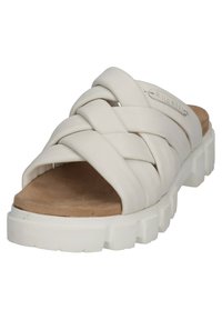 White slide sandal featuring a braided upper design and a textured, cushioned footbed. Chunky white sole adds stability and height.