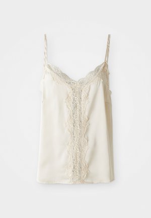 Cream satin camisole with narrow straps and floral lace trim down the center and neckline, displayed on a white background.