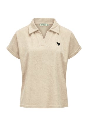 Beige short-sleeve terry cloth shirt with open collar and small black heart emblem on left chest.