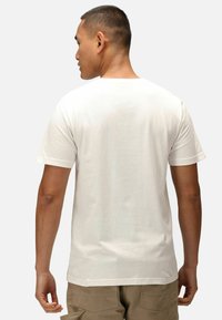 Bílý bavlněný tričko s krátkým rukávem, jednoduchý design zadní strany, kulatý výstřih, hladká textura a volný střih. V kombinaci s khaki kalhotami.