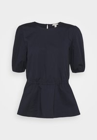 Marineblå peplum-top i en blanding af bomuldsstof. Har korte pufærmer, en rund halsudskæring og en subtil detalje med en nøglehul i ryggen.