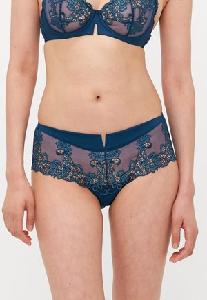 Teal lingerie set featuring a sheer lace bra with floral patterns and matching lace briefs with a v-cut front and soft fabric detailing.