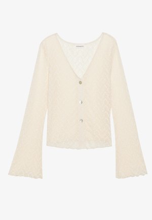 Cardigan en dentelle couleur crème avec un col en V, des manches longues évasées et cinq boutons. Présente un motif chevrons texturé et des bords festonnés.