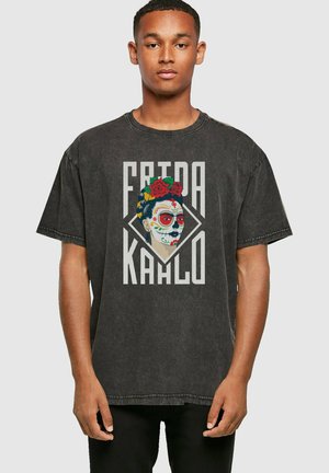 Dark gray oversized t-shirt featuring a colorful Frida Kahlo graphic, with floral accents and bold lettering on a textured fabric.