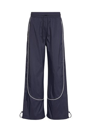 Marineblå vidtbenede træningsbukser med hvide striber langs sider og knæ, elastisk talje med snøre og justerbare kanter.