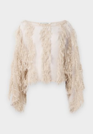 Kortermet crop-top i beige med teksturerte frynser langs fronten og ermene. Gjennomsiktig stoff med en glatt innerside.