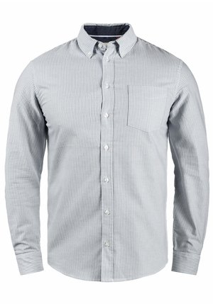 Stripet langermet skjorte i lys blå og hvit, med krage som lukkes med knapper, frontlomme og myk teksturert bomullsstoff.