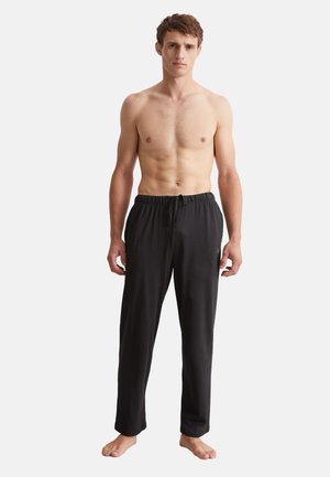 Pantalons de pyjama noirs en tissu doux, dotés d'une taille élastique avec cordon de serrage, coupe droite, sans motifs ni quincaillerie visibles.