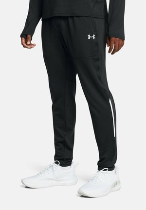 Pantalons de jogging noirs avec poches latérales et détail de bande blanche. Fabriqués en tissu doux, avec une coupe décontractée et une taille élastique.