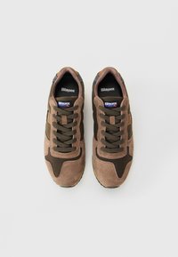 Pair of brown and olive Blauer suede sneakers with laces, viewed from above on a white background.