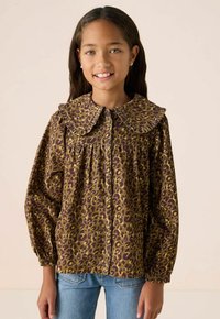 Leopard print button-up blouse with a large ruffled collar, long puff sleeves, and a relaxed fit. Fabric appears textured in brown and gold tones.