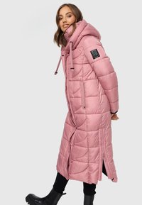 Pink padded long jacket with a hood, zippered front, side pockets, and elastic accents. Quilted texture with a glossy finish.