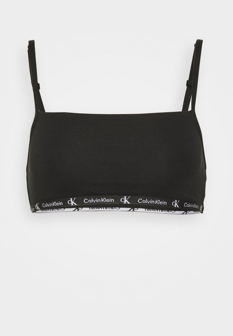Czarny biustonosz braletka wykonany z gładkiego materiału z cienkimi regulowanymi ramiączkami. Posiada białą taśmę z logo Calvin Klein na dole.