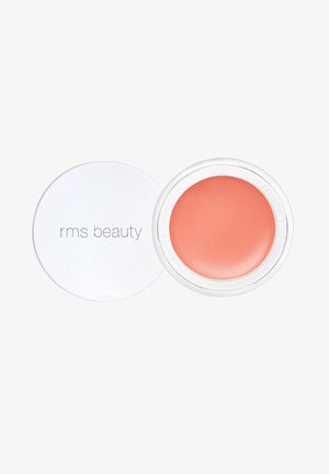 Blush crème dans un pot rond et transparent avec un couvercle blanc. Couleur pêche douce et texture lisse. L'étiquette indique "rms beauty."