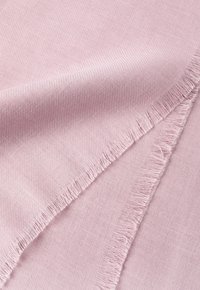 Ljust rosa tyg med en slät struktur och fransiga kanter, som visar ett subtilt vävt mönster. Mjukt och följsamt, idealiskt för olika användningsområden.