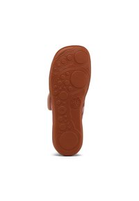 Schoenzool in bruin rubber met een gestructureerd oppervlak dat verheven ronde en ovale patronen vertoont. Gladde rand met een label dat aan de zijkant is geperst.