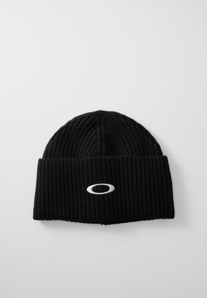 Black knitted beanie with a ribbed texture, featuring a folded cuff and a white oval logo stitched on the front.