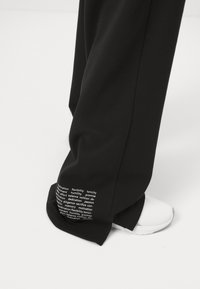 Champion EMOTIONAL DANCE WIDE LEG PANTS - Treniņtērpa apakšdaļas - black