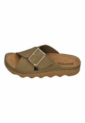 Brown open-toe slide sandal with cork sole, wide adjustable strap with silver buckle, and cushioned footbed.