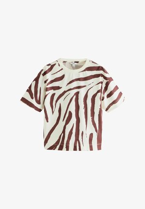Short-sleeve t-shirt in cream with a brown zebra stripe pattern. Soft, textured cotton material with a relaxed fit and crew neck.
