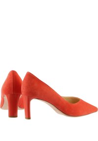 Red suede high-heel pumps with a pointed toe and a sleek design. The heel is a glossy finish, providing a contrast to the matte texture.