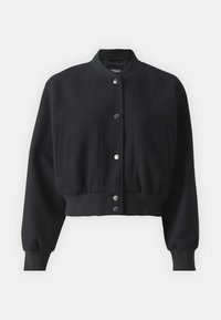 Svart cropped jacka i mjukt tyg, med rundad krage, tryckknappar och två stora framfickor samt en figursydd midja.