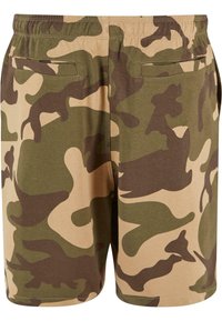 Camo print shorts in shades of green and beige, made of soft fabric. Features an elastic waistband and two back pockets.