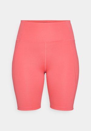 High-waisted coral cycling shorts made of stretchy material, featuring smooth texture, side seams, and knee-length design.
