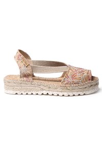 Tan espadrille sandal med rosa och silverblommönster, elastiska remmar och en texturerad jute-rep sula. Platt plattform design.