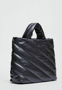 Borsa a tracolla nera trapuntata in pelle lucida, con cuciture diagonali, due manici corti e una struttura morbida e imbottita.
