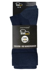 Marinefarbene Merinowoll-Wandersocken mit einem gerippten oberen Bereich und einem weichen, strukturierten unteren Teil. Das Etikett der Verpackung weist auf Wärme und Stabilität hin. Größe 35/38.