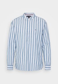 Camicia a maniche lunghe blu e bianca a righe, con colletto alla coreana, chiusura con bottoni e righe decorative sui polsini. Tessuto leggero.