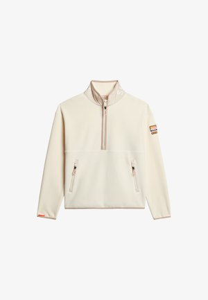 Cremefleece pullover med høj krave, halv lynlås foran, to lynlåslommer og kontrastfarvede pink accenter på lynlåse og manchetter.