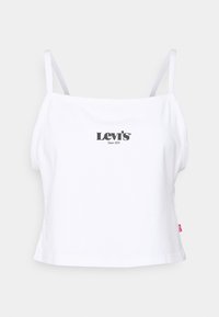 Vit bomullskort topp med tunna axelremmar, med en svart Levi's-logotyp och texten "Sedan 1873" på bröstet. Enkelt design, rena linjer.