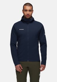 Navy blue, lightweight insulated jacket with hood, featuring a front zipper, logo on the chest, and zippered side pockets.