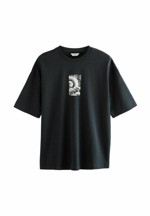 Black oversized short-sleeve T-shirt with a small white rectangular graphic of ocean waves and a sun on the chest.